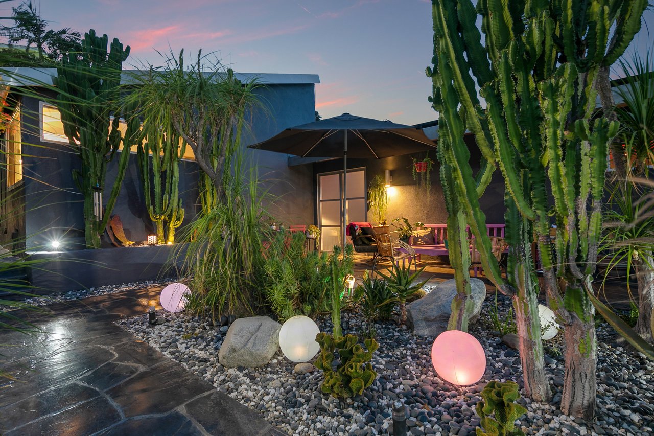 The private entrance courtyard lit by glowing garden spheres
