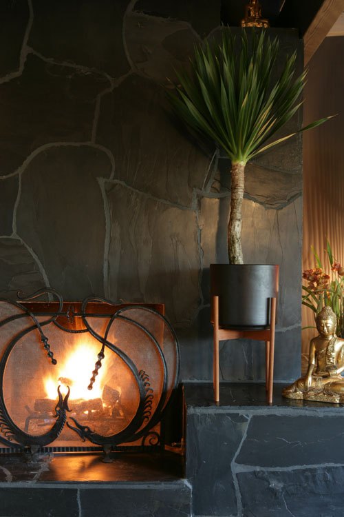 The glowing fire in the slate fireplace