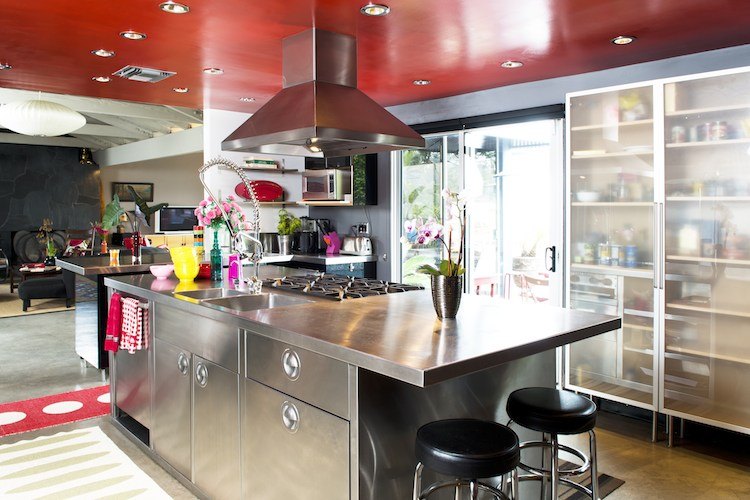 The kitchen with stainless-steel island and a vivid red ceiling