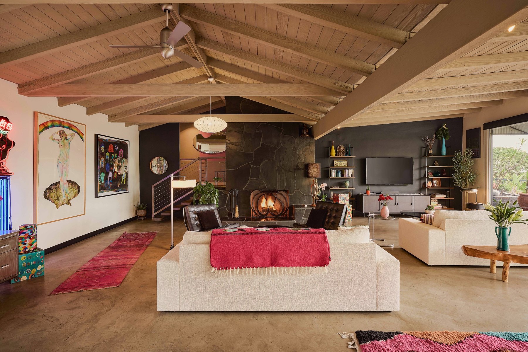 A wide view of the living room and exposed timber ceiling