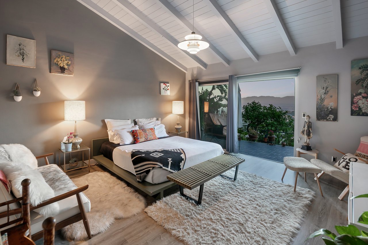 The primary bedroom with a king bed and garden outlook