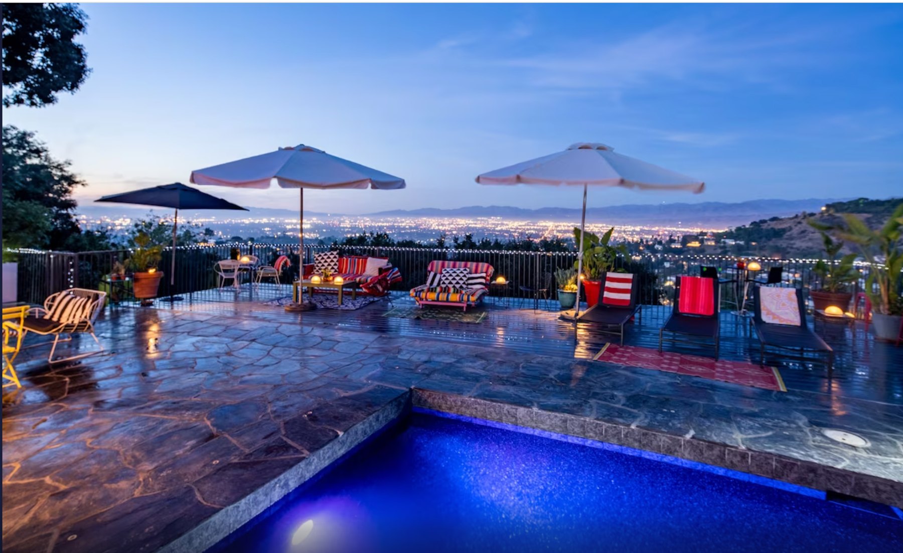 The private pool and expansive slate deck overlooking Los Angeles at twilight